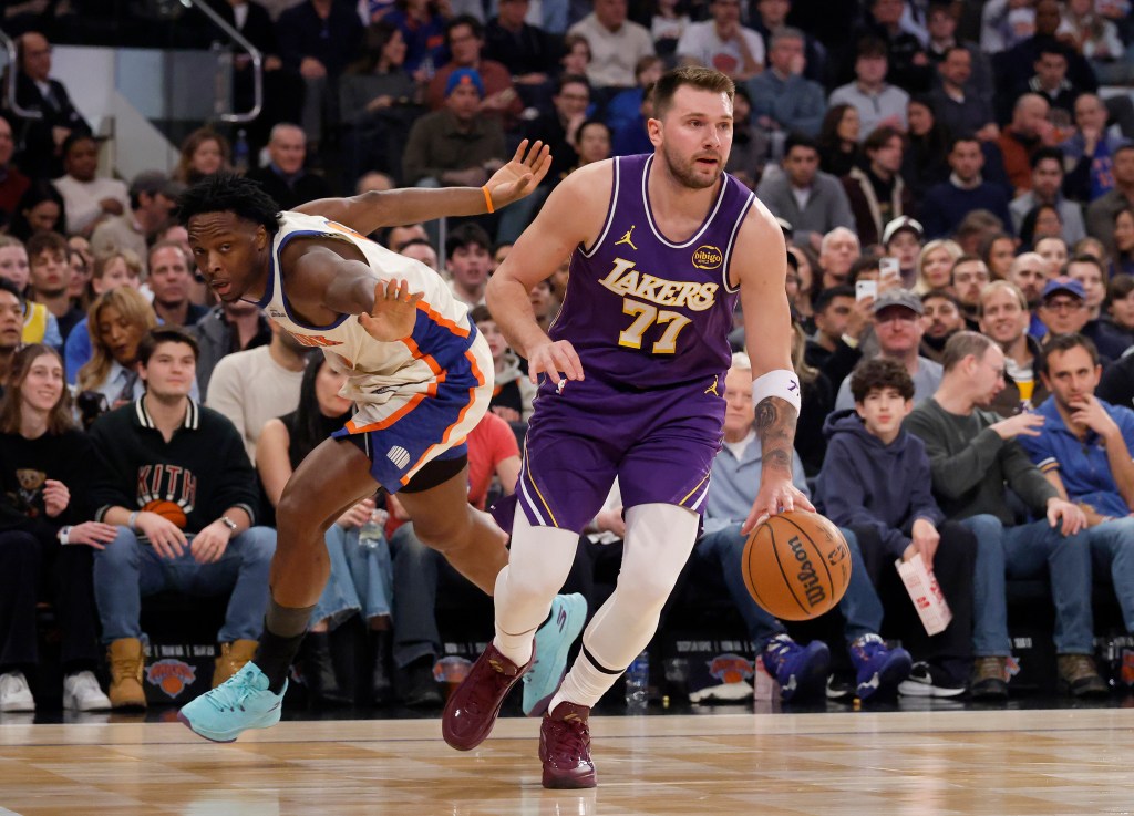 Lakers guard Luka Doncic dribbles past Knicks forward Og Anunoby.