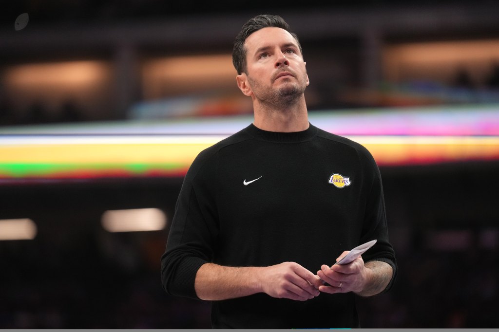 Los Angeles Lakers head coach JJ Redick looking up during a timeout.