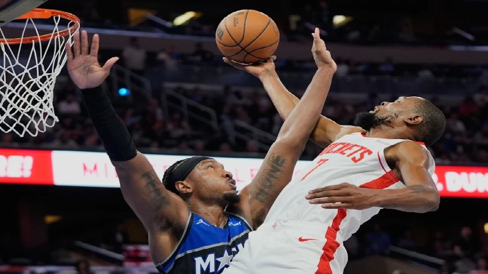Houston Rockets forward Kevin Durant, right, goes to the basket against Orlando Magic center Wendell Carter Jr. during the second half of an NBA basketball game, Thursday, Feb. 26, 2026, in Orlando, Fla. (AP Photo/John Raoux)