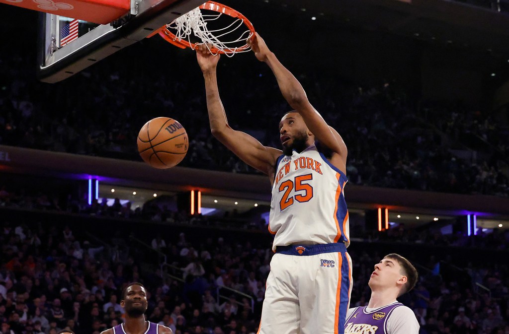 New York Knicks guard Mikal Bridges dunking the ball during a game against the Los Angeles Lakers.