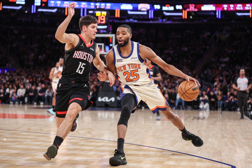New York Knicks guard Mikal Bridges (25) drives past Houston Rockets guard Reed Sheppard (15).