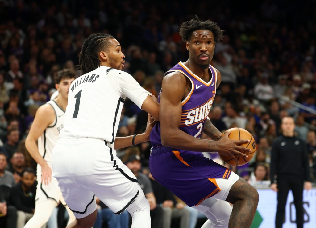 Jan 27, 2026; Phoenix, Arizona, USA; Phoenix Suns forward Nigel Hayes-Davis (21) drives to the basket against Brooklyn Nets forward Ziaire Williams (1) in the first half at Mortgage Matchup Center. Mandatory Credit: Mark J. Rebilas-Imagn Images