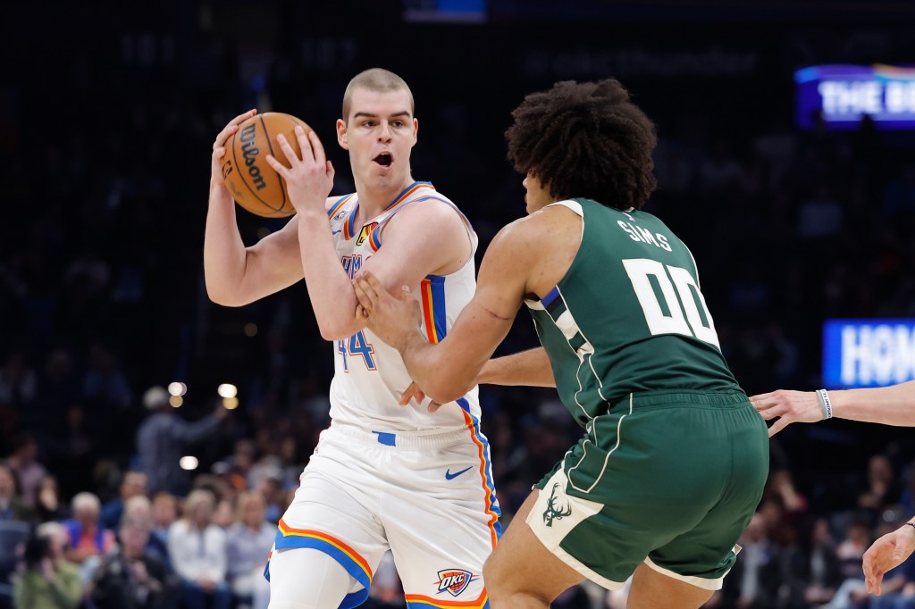 Oklahoma City Thunder guard Nikola Topic (44) holds the ball against Milwaukee Bucks center Jericho Sims (00).