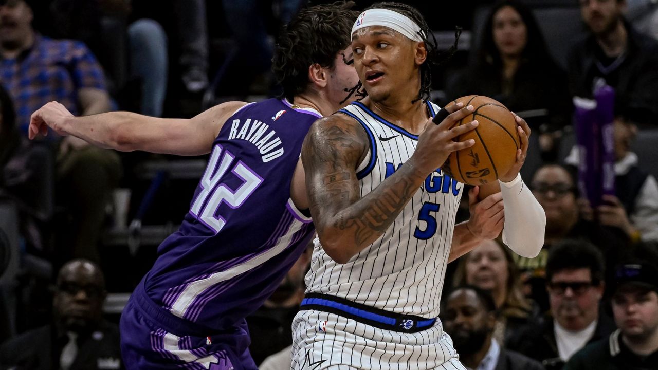 Magic forward Paolo Banchero (5) works the ball past Kings center Maxime Raynaud (42) on Thursday night in Sacramento. (AP Photo/Randall Benton)