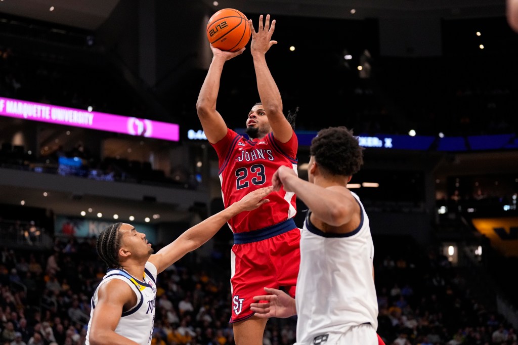 St. John's Red Storm guard-forward Bryce Hopkins (23) shoots over Marquette Golden Eagles forward Royce Parham (13).