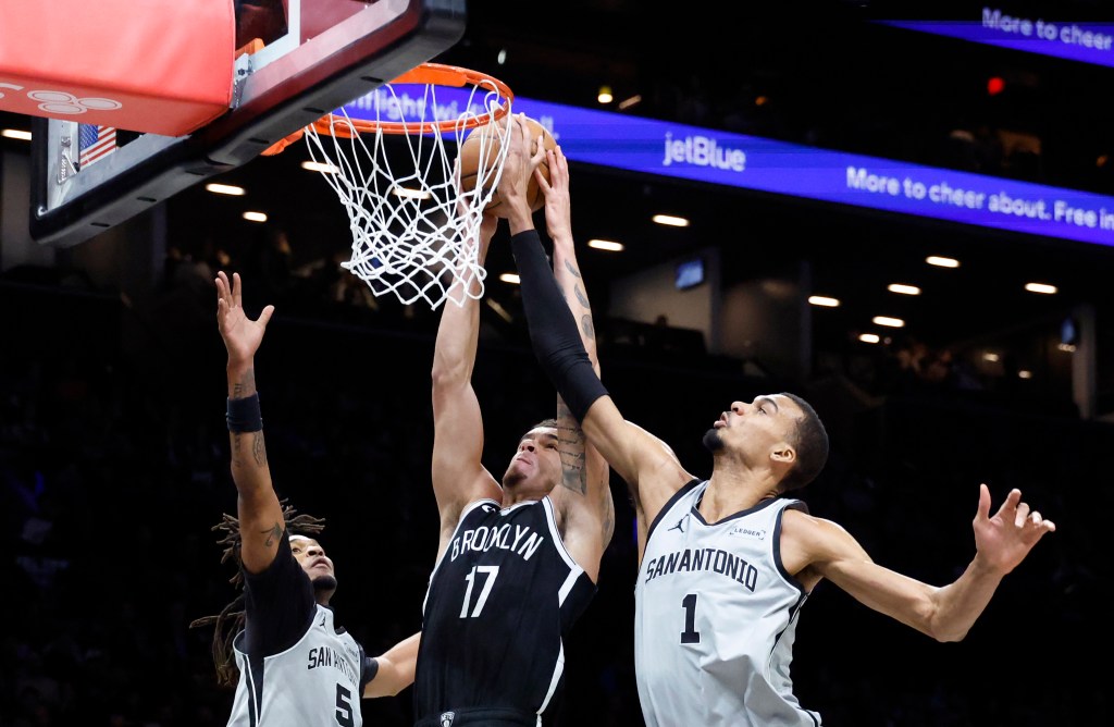 Michael Porter Jr. (C) tries to dunk but is blocked by San Antonio Spurs forward Victor Wembanyama (R) and teammate San Antonio Spurs guard Stephon Castle (L) in the first half at the Barclays Center in Brooklyn, New York, USA, Thursday, February 26, 2026. 