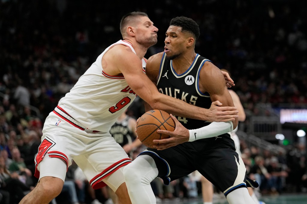 Nikola Vucevic #9 of the Chicago Bulls defends Giannis Antetokounmpo #34 of the Milwaukee Bucks.