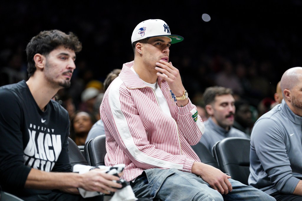 Brooklyn Nets player Michael Porter Jr. watches a game from the bench.