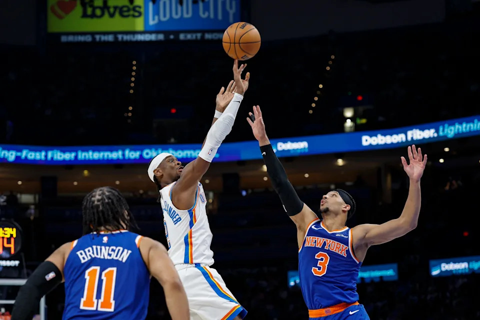 Mar 29, 2026; Oklahoma City, Oklahoma, USA; Oklahoma City Thunder guard Shai Gilgeous-Alexander (2) shoots between New York Knicks guard Jalen Brunson (11) and guard Josh Hart (3) during the second half at Paycom Center. Mandatory Credit: Alonzo Adams-Imagn Images