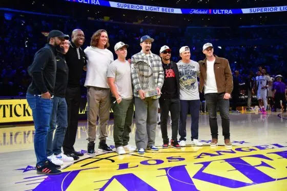 Los Angeles Dodgers player Teoscar Hernandez, majority owner Mark Walter, minority owner Magic Johnson, Tyler Glasnow, Will Smith, Blake Snell, Mookie Betts, Alex Call and Evan Phillips pose for a photo during the first half at Crypto.com Arena on Nov 5, 2025.