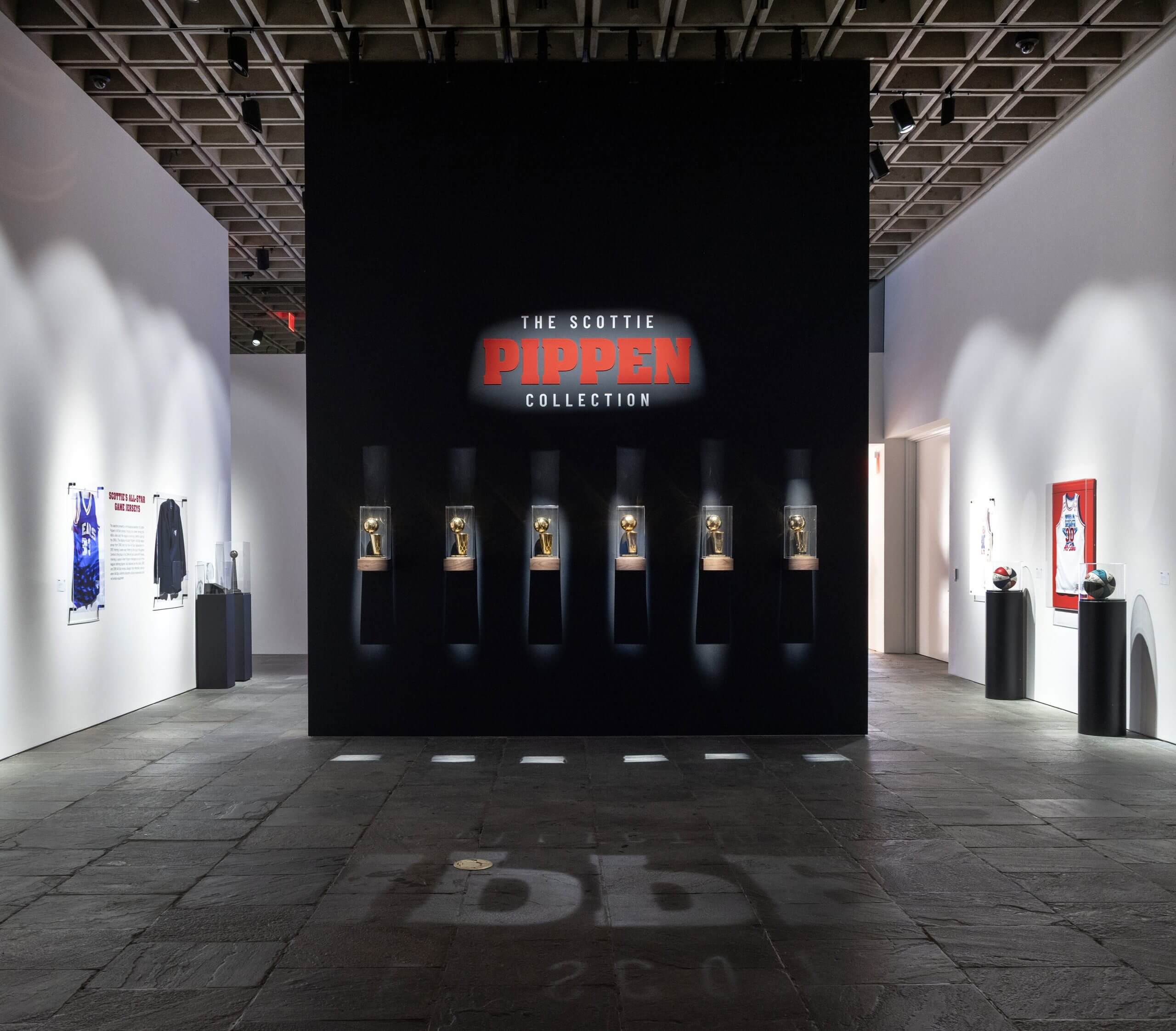 The Scottie Pippen Collection on display, with trophies in a lighted case. 