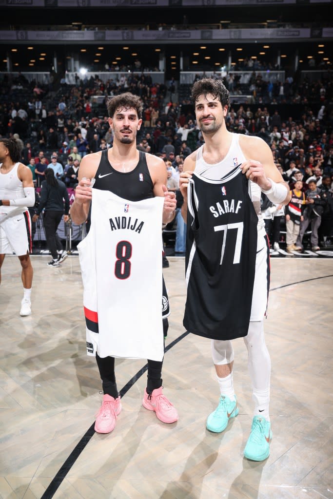 Deni Avdija (R.) and Ben Saraf pose together after the Nets-Blazers game on March 16, 2026. NBAE via Getty Images