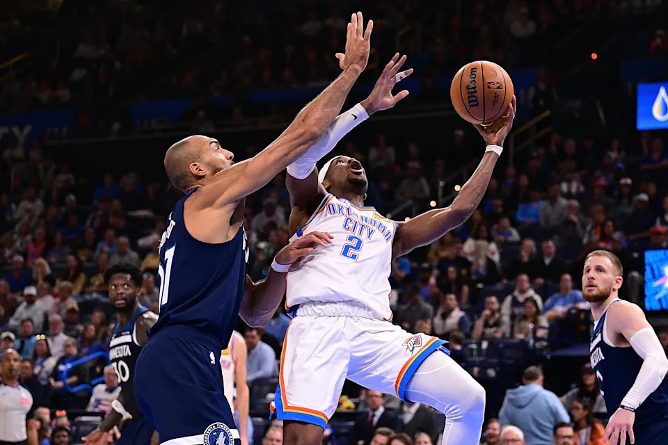 OKLAHOMA CITY, OKLAHOMA - MARCH 15: Shai Gilgeous-Alexander #2 of the Oklahoma City Thunder attempts a shot in front of Rudy Gobert #27 of the Minnesota Timberwolves during the second half at Paycom Center on March 15, 2026 in Oklahoma City, Oklahoma. NOTE TO USER: User expressly acknowledges and agrees that, by downloading and or using this photograph, User is consenting to the terms and conditions of the Getty Images License Agreement. (Photo by Joshua Gateley/Getty Images)