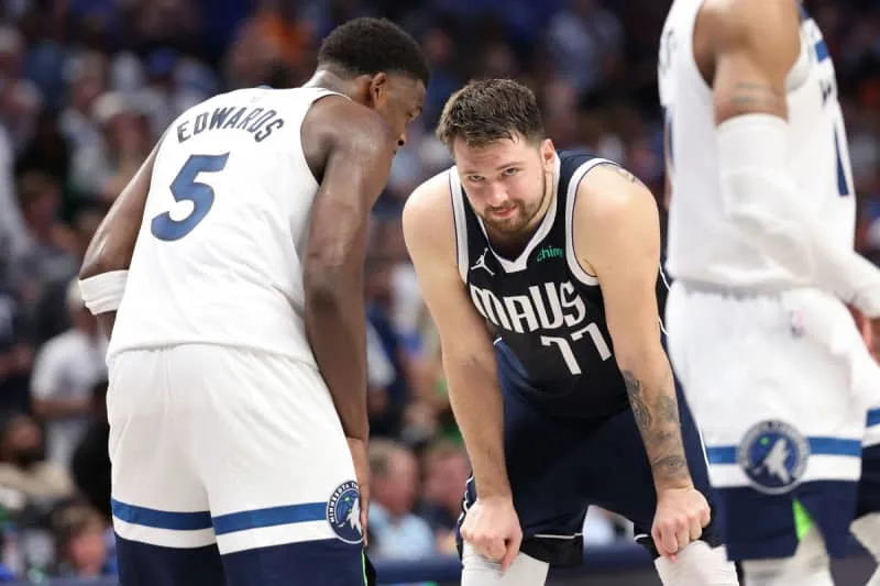 May 28, 2024; Dallas, Texas, USA; Minnesota Timberwolves guard Anthony Edwards (5) speaks to Dallas Mavericks guard Luka Doncic (77) during the fourth quarter of game four of the western conference finals for the 2024 NBA playoffs at American Airlines Center. Mandatory Credit: Kevin Jairaj-USA TODAY Sports