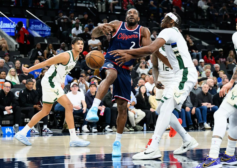 Clippers forward Kawhi Leonard is fouled by Bucks center Myles Turner on a drive in the first half of their game March 23 at the Intuit Dome.