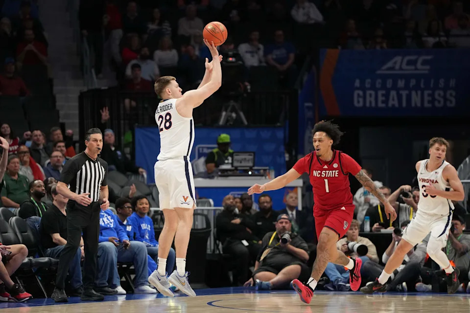 Mar 12, 2026; Charlotte, NC, USA; Virginia Cavaliers forward Thijs de Ridder (28) shoots as NC State Wolfpack forward Darrion Williams (1) defends in the first half at Spectrum Center. Mandatory Credit: Bob Donnan-Imagn Images
