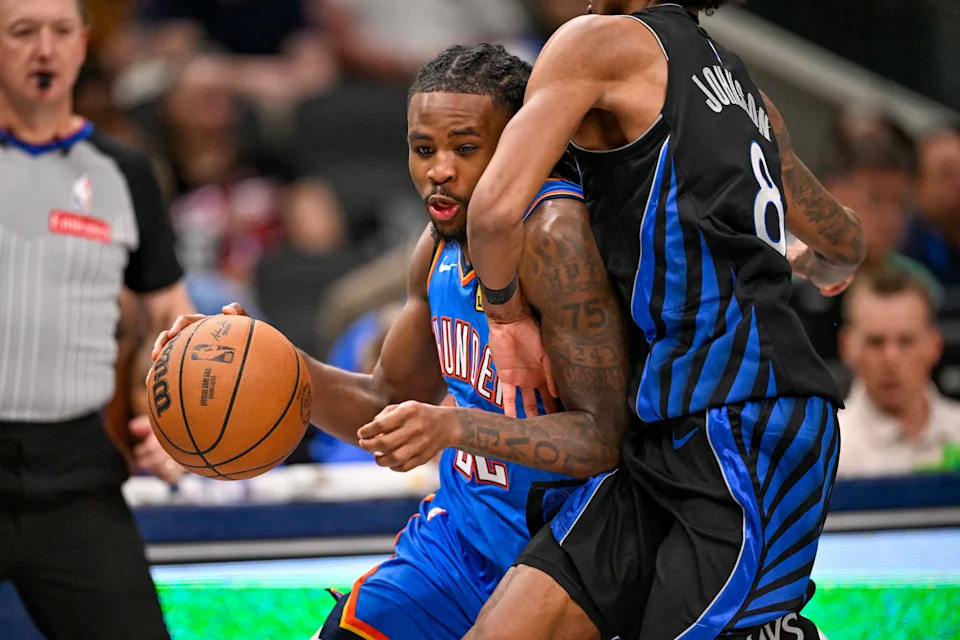 Mar 1, 2026; Dallas, Texas, USA; Oklahoma City Thunder guard Cason Wallace (22) looks to move the ball past Dallas Mavericks guard AJ Johnson (8) during the second half at the American Airlines Center. Mandatory Credit: Jerome Miron-Imagn Images