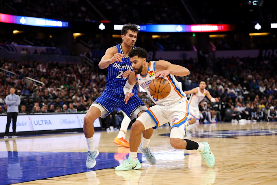 Mar 17, 2026; Orlando, Florida, USA; Oklahoma City Thunder guard Ajay Mitchell (25) is guarded by Orlando Magic forward Tristan da Silva (23) in the fourth quarter at Kia Center. Mandatory Credit: Nathan Ray Seebeck-Imagn Images