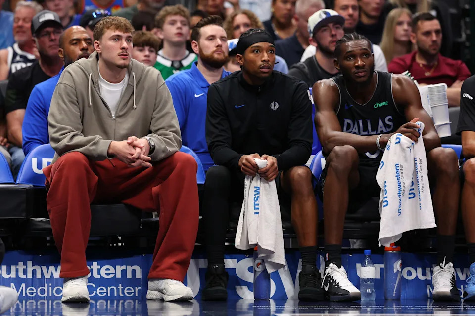 DALLAS, TEXAS - MARCH 01: Cooper Flagg #32, Brandon Williams #10 and Moussa Cisse #30 of the Dallas Mavericks watch play from their team's bench during the third quarter of the game against the Oklahoma City Thunder at American Airlines Center on March 01, 2026 in Dallas, Texas. NOTE TO USER: User expressly acknowledges and agrees that, by downloading and or using this photograph, user is consenting to the terms and conditions of the Getty Images License Agreement. (Photo by Sam Hodde/Getty Images)