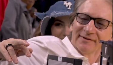 Political commentator Bill Maher shows off his injured finger after a collision at an NBA game