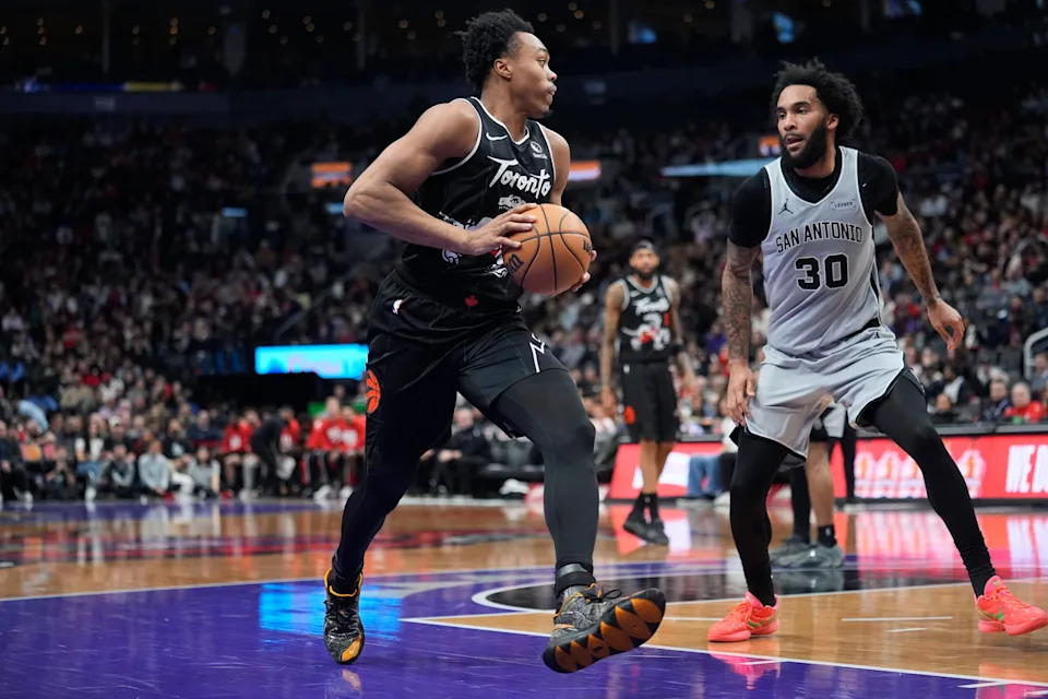 Feb 25, 2026; Toronto, Ontario, CAN; Toronto Raptors guard Scottie Barnes (4) controls the ball against San Antonio Spurs forward Julian Champagnie (30) during the second half at Scotiabank Arena. Mandatory Credit: John E. Sokolowski-Imagn Images