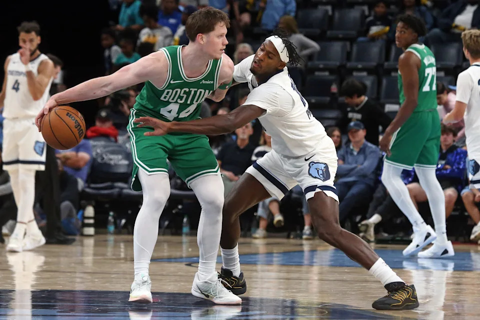 Oct 8, 2025; Memphis, Tennessee, USA; Boston Celtics guard Max Shulga (44) dribbles as Memphis Grizzlies forward Olivier-Maxence Prosper (18) defends during the fourth quarter at FedExForum. Mandatory Credit: Petre Thomas-Imagn Images