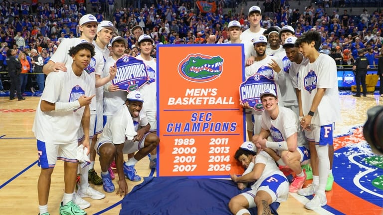 Florida players celebrate after their SEC regular season title after...