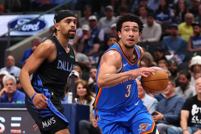 DALLAS, TEXAS - MARCH 01: Jared McCain #3 of the Oklahoma City Thunder makes a move with the ball past Ryan Nembhard #9 of the Dallas Mavericks during the second quarter at American Airlines Center on March 01, 2026 in Dallas, Texas. NOTE TO USER: User expressly acknowledges and agrees that, by downloading and or using this photograph, user is consenting to the terms and conditions of the Getty Images License Agreement. (Photo by Sam Hodde/Getty Images)