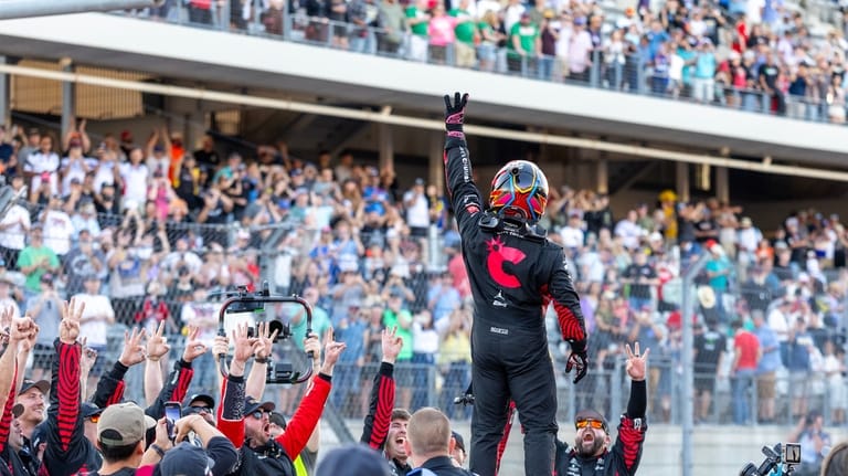 23XI Racing's Tyler Reddick, center, celebrates his win during a...