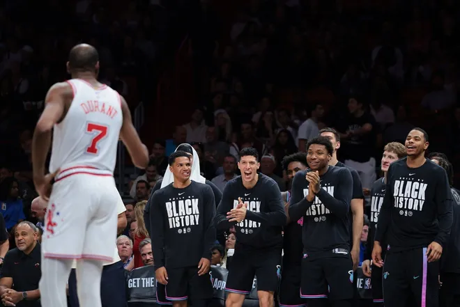 Feb 28, 2026; Miami, Florida, USA; Miami Heat guard Dru Smith (12), forward Simone Fontecchio (0), forward Myron Gardner (15) and forward Keshad Johnson (16) react from the bench toward Houston Rockets forward Kevin Durant (7) during the fourth quarter at Kaseya Center.
