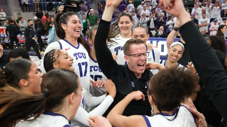 TCU head coach Mark Campbell, center right, celebrates with his...