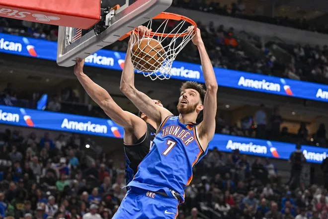 Mar 1, 2026; Dallas, Texas, USA; Oklahoma City Thunder center Chet Holmgren (7) dunks the ball past Dallas Mavericks forward Dwight Powell (7) during the second half at the American Airlines Center.