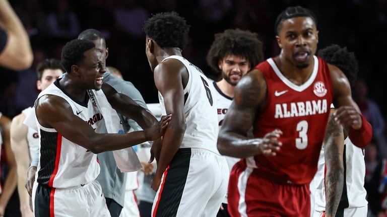 Georgia guard Justin Bailey, left, reacts with forward Kanon Catchings,...