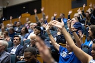 Members of the audience show support to a speaker who spoke in favor of keeping Dallas City...