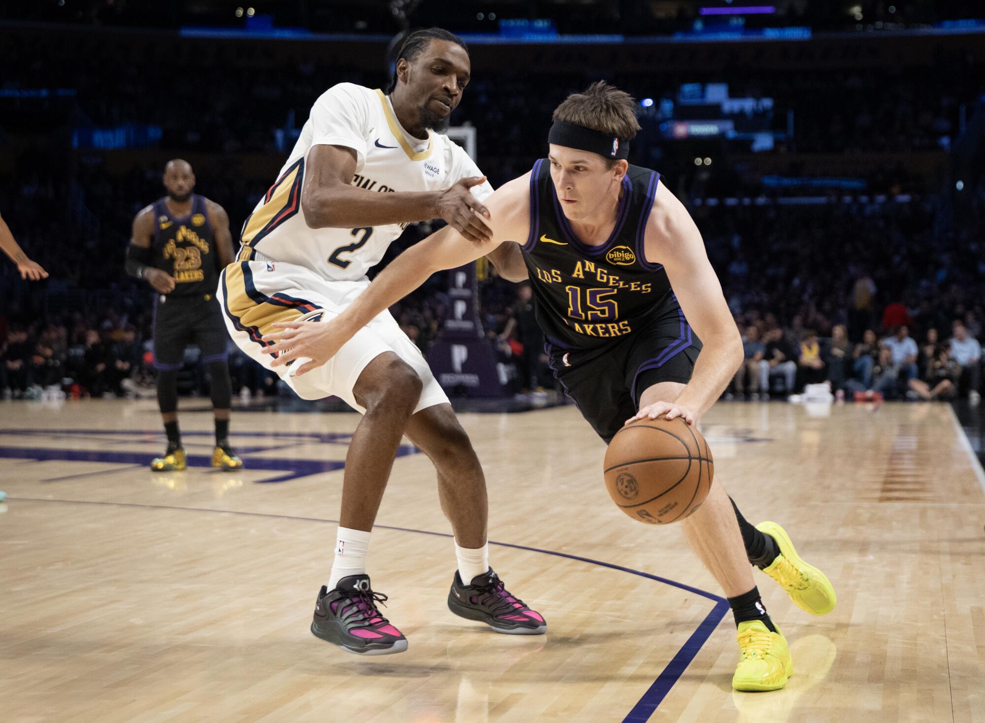 Lakers guard Austin Reaves dribbles around Pelicans forward Herbert Jones on Tuesday at Crypto.com Arena.