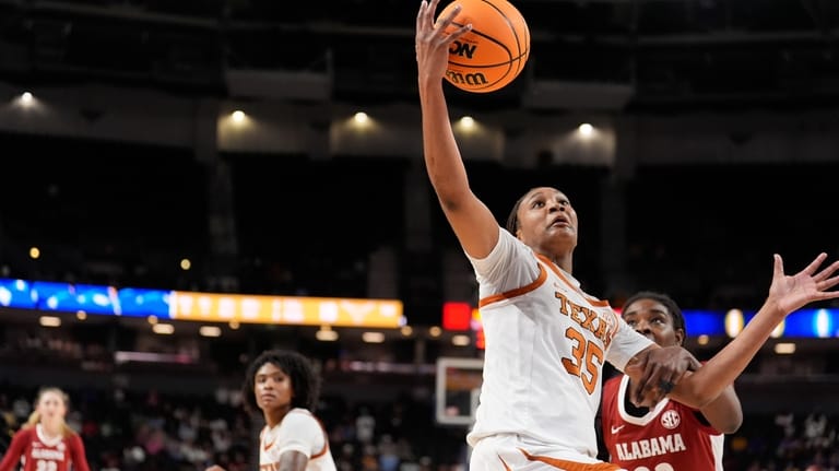 Texas forward Madison Booker vies for the ball with Alabama...