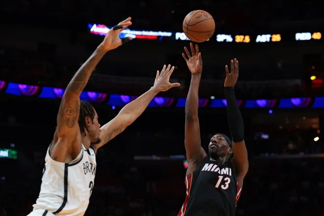 Mar 3, 2026; Miami, Florida, USA; Miami Heat center Bam Adebayo (13) shoots the basketball over Brooklyn Nets center Nic Claxton (33) during the fourth quarter at Kaseya Center.