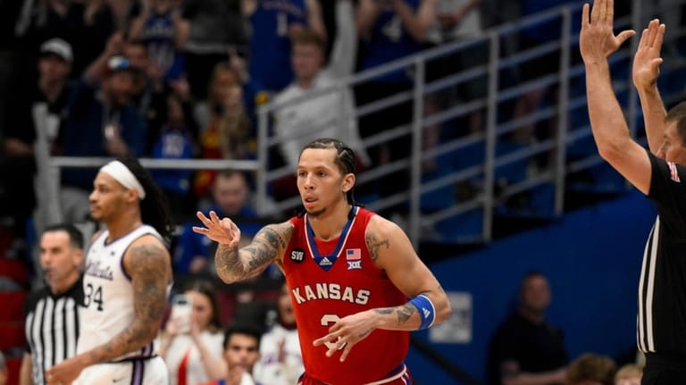 Kansas guard Tre White (3) celebrates a three-point basket against...
