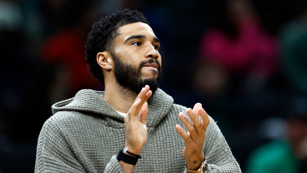 Jayson Tatum claps on bench