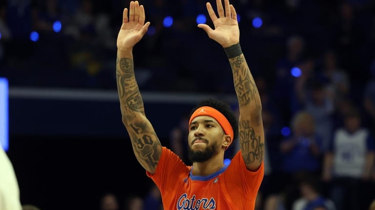 Florida's Boogie Fland celebrates after his team defeated Kentucky in...