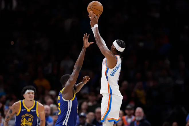 Mar 7, 2026; Oklahoma City, Oklahoma, USA; Oklahoma City Thunder guard Shai Gilgeous-Alexander (2) shoots over Golden State Warriors forward Draymond Green (23) during the second half at Paycom Center. Mandatory Credit: Alonzo Adams-Imagn Images