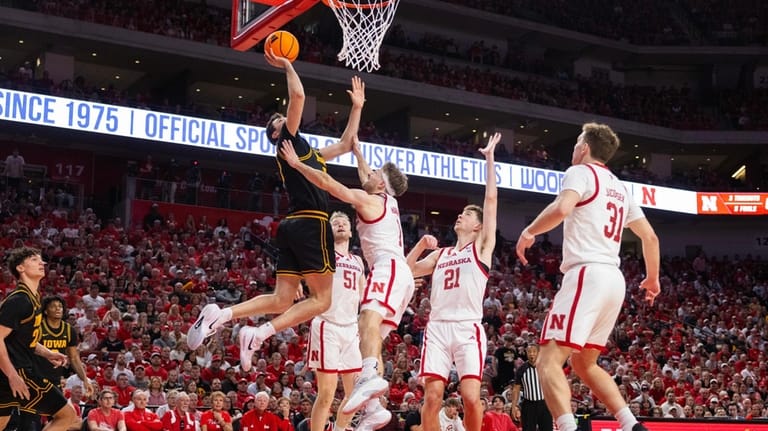 From left, Iowa's Alvaro Folgueiras shoots against Nebraska's Rienk Mast,...