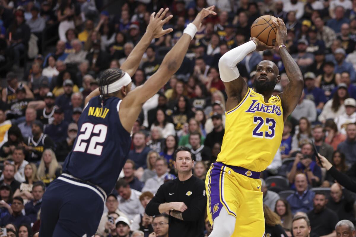Lakers star LeBron James shoots over Denver's Zeke Nnaji to set the all-time NBA record for most successful field goals.