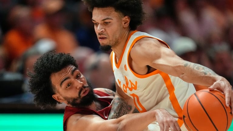 Alabama guard Houston Mallette, left, reaches for the ball against...