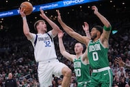 Dallas Mavericks forward Cooper Flagg (32) shoots over Boston Celtics' Jayson Tatum (0) and...