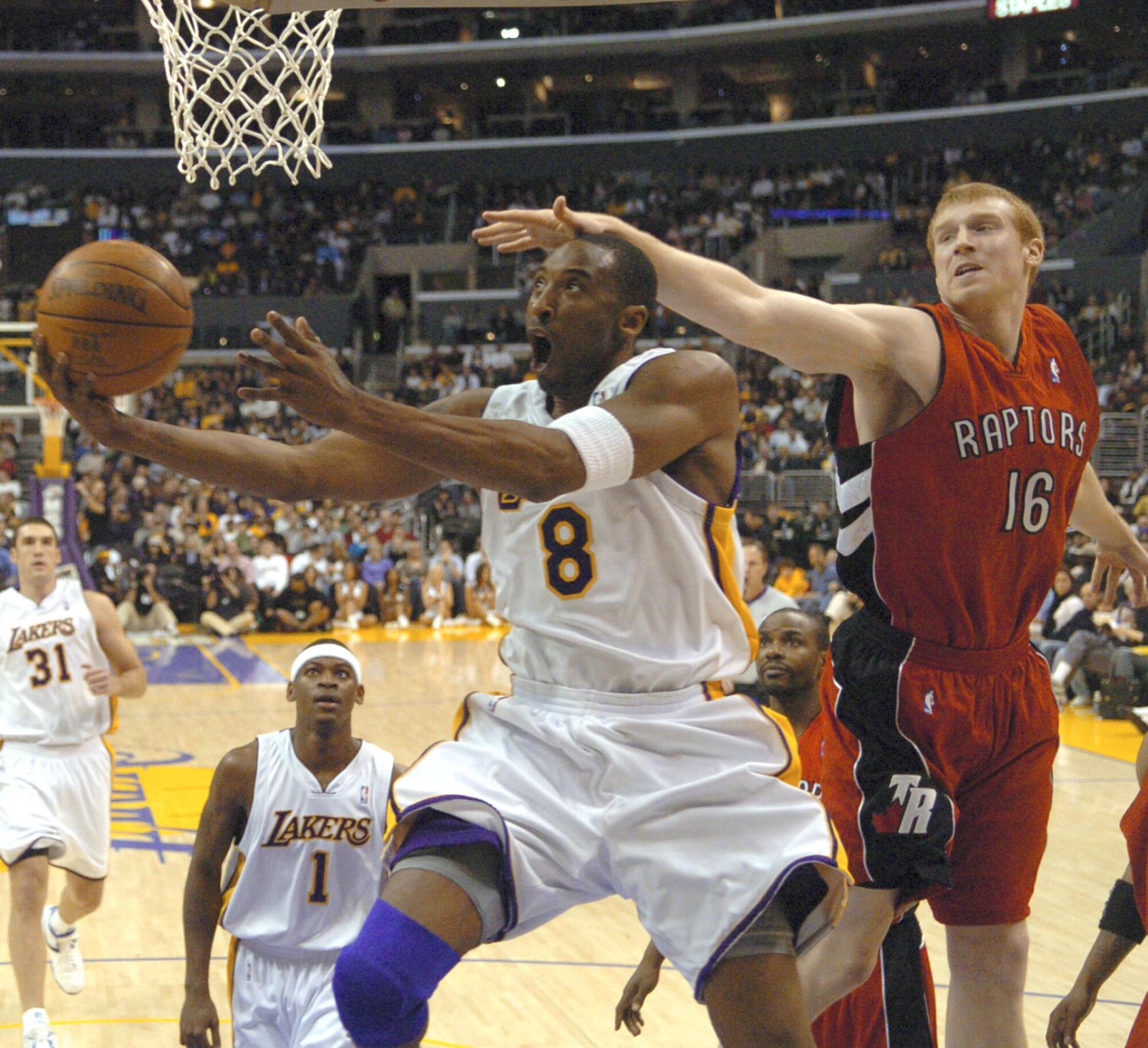 Lakers star Kobe Bryant scores in front of Toronto's Matt Bonner on his way to scoring 81 points in 2006.