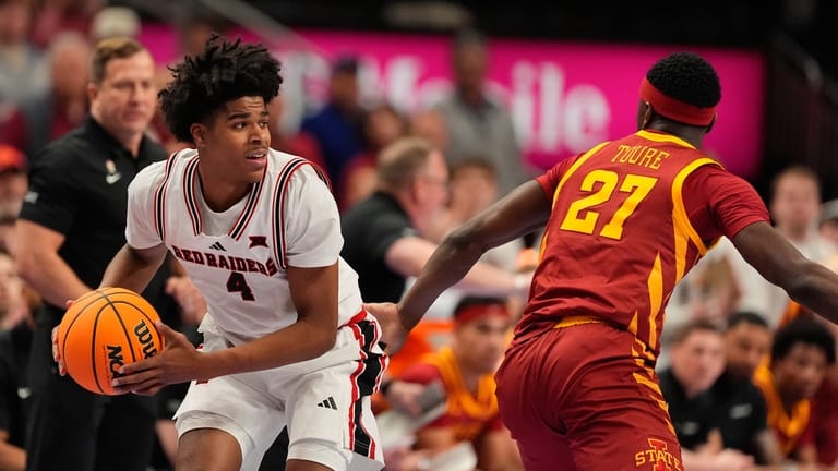 Texas Tech's Christian Anderson (4) looks to pass round Iowa...