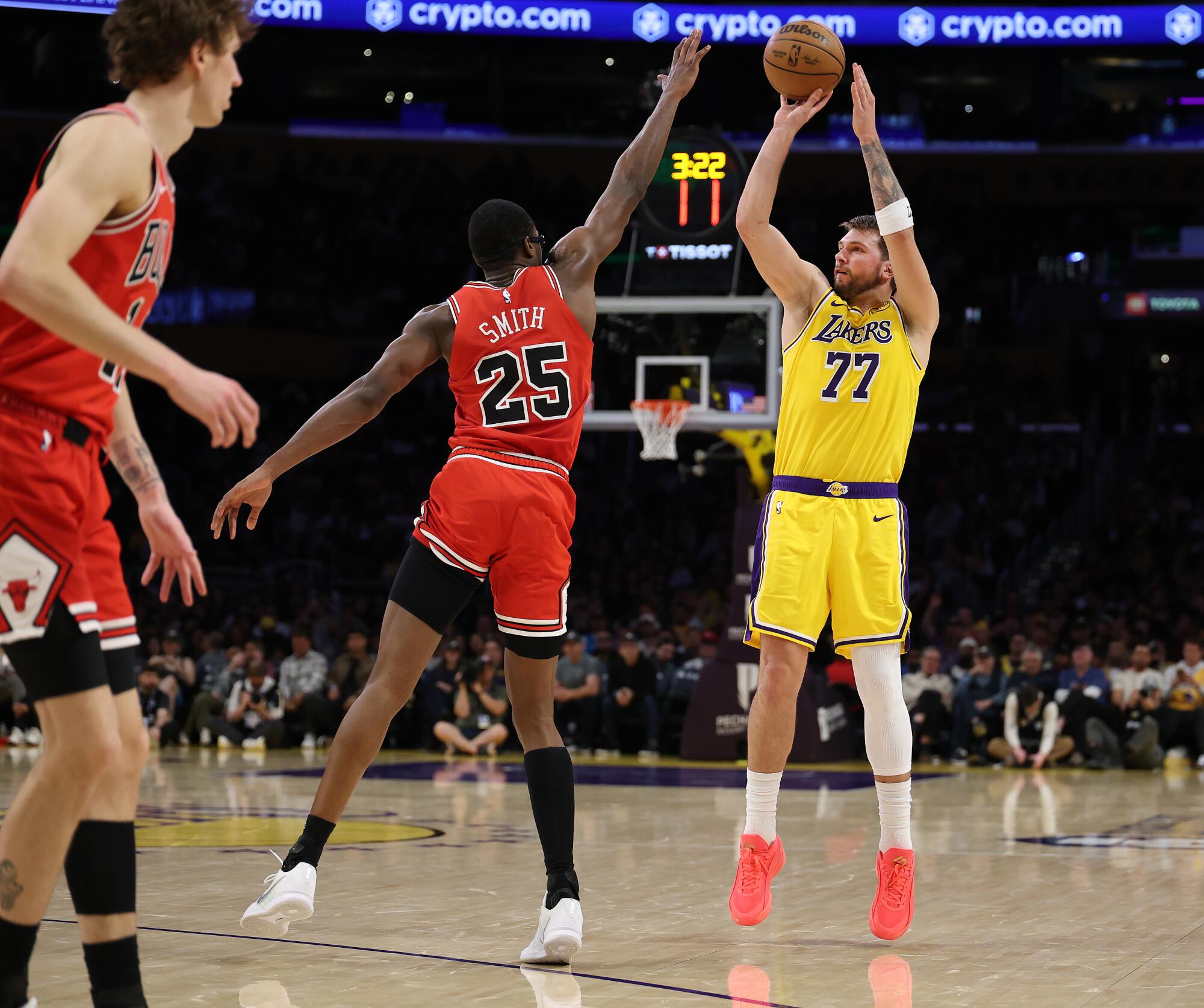 Luka Doncic shoots a three-pointer over Bulls forward Jalen Smith during the Lakers' win Thursday.