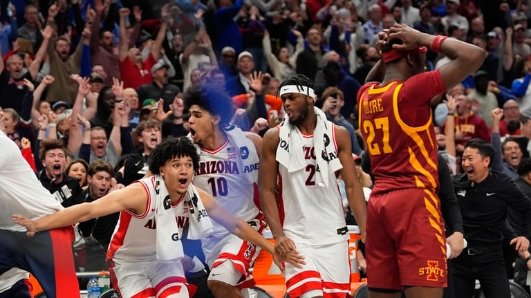 Members of Arizona react after teammate Jaden Bradley made a...