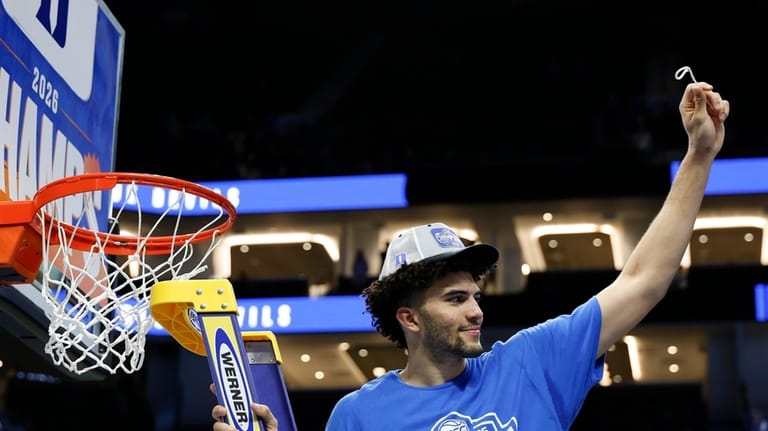 Duke forward Cameron Boozer cuts down the net after his...